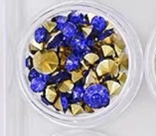 Assorted faceted nail embellishments in a twelve-compartment storage case