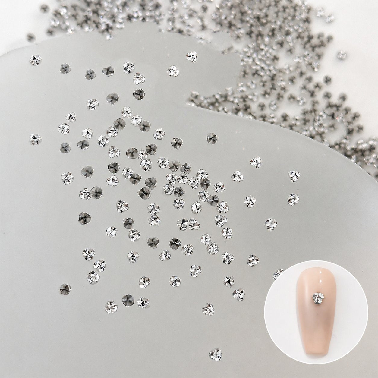 Silver nail rhinestones with a nude nail swatch
