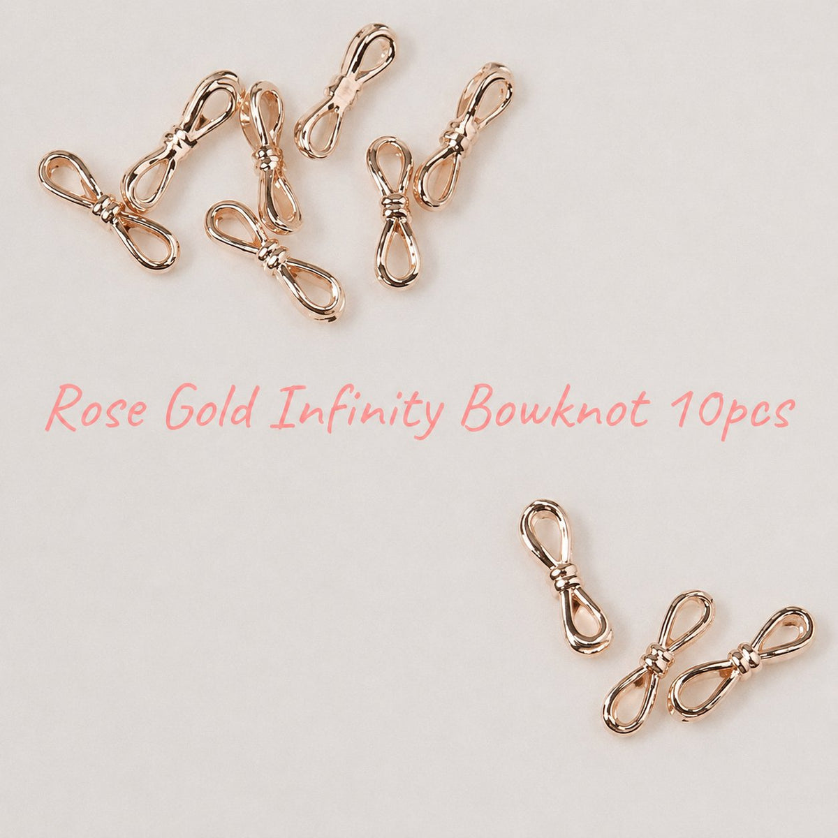 Rose-gold infinity bowknots scattered on a white background