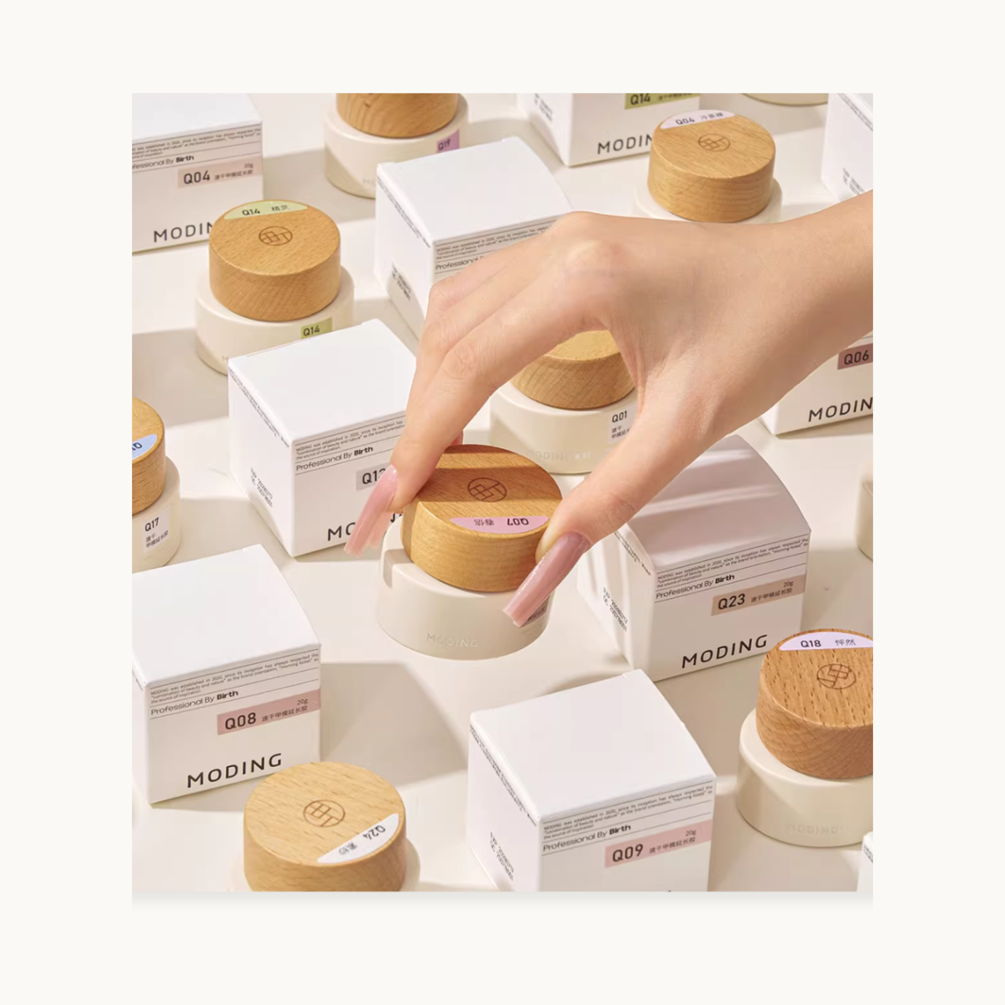 Extension gel jars and boxes with a hand selecting one jar