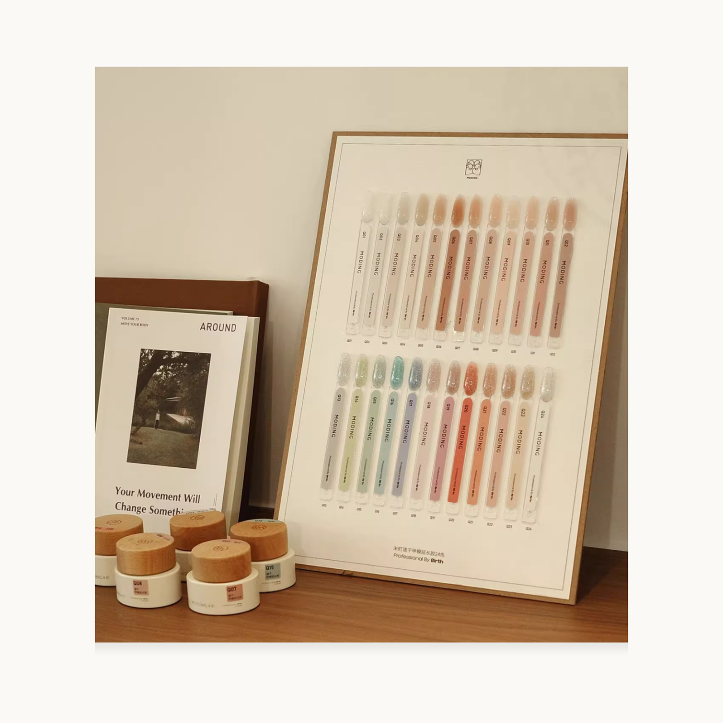 Extension gel swatch board with gel jars and a booklet on a studio table