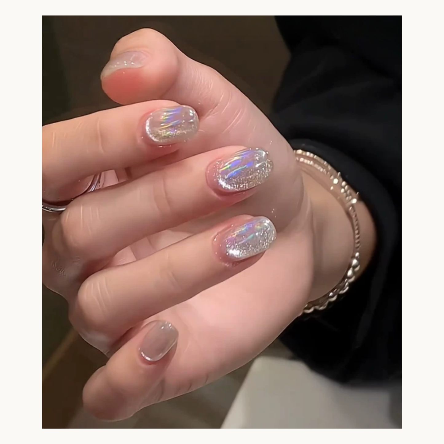 NF Select Holographic Aurora Nail Transfer Foil applied on manicure, showing shimmering iridescent effect on clear base nails