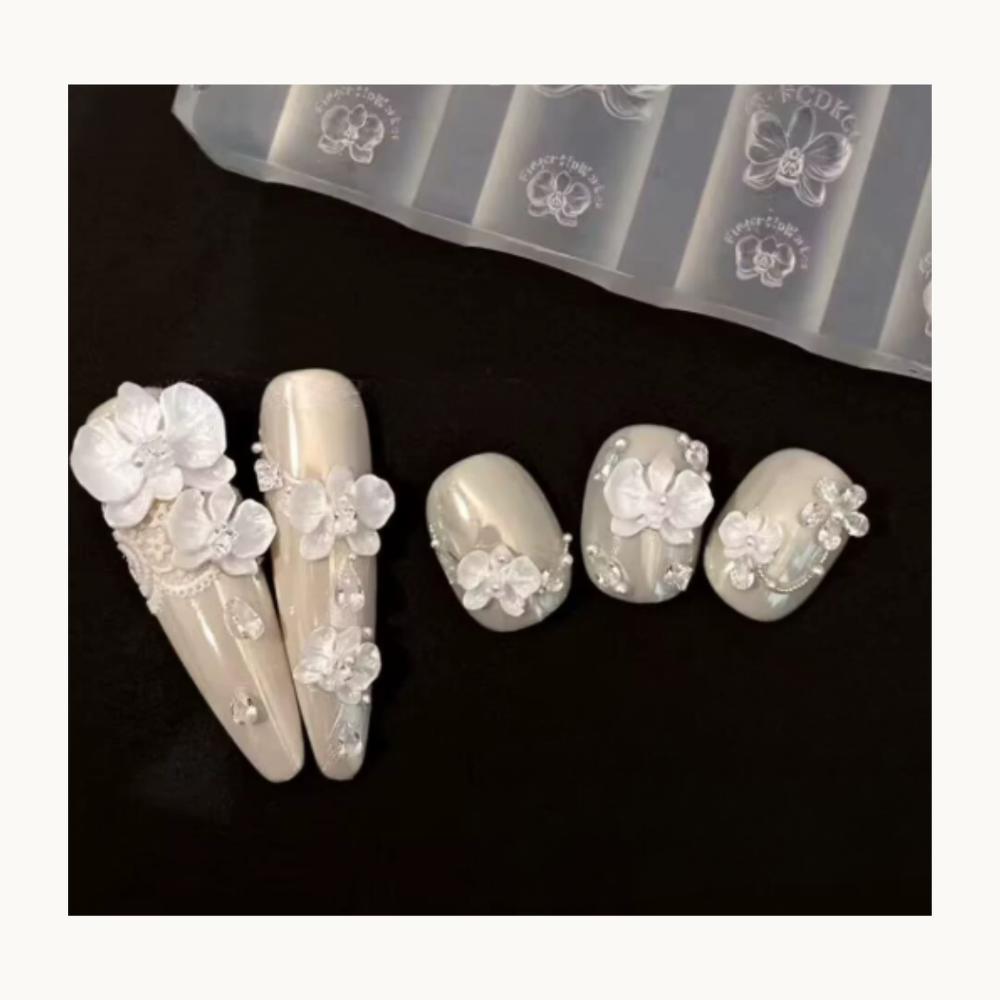 NF Select Phalaenopsis Orchid Nail Mold application, showing finished 3D phalaenopsis orchid nail charms on elegant manicures