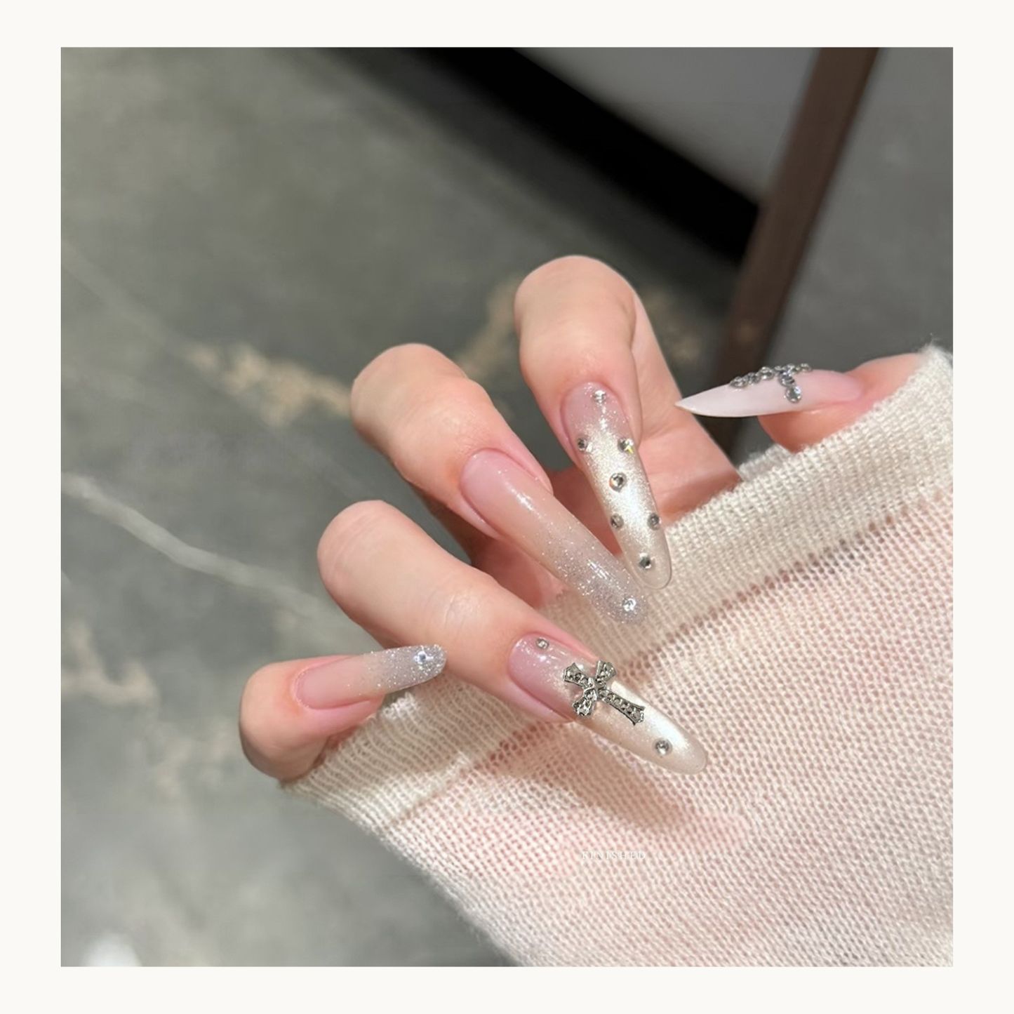 Silver gothic cross nail charms applied on long acrylic nails, Y2K inspired chrome nail design for USA and Canada market