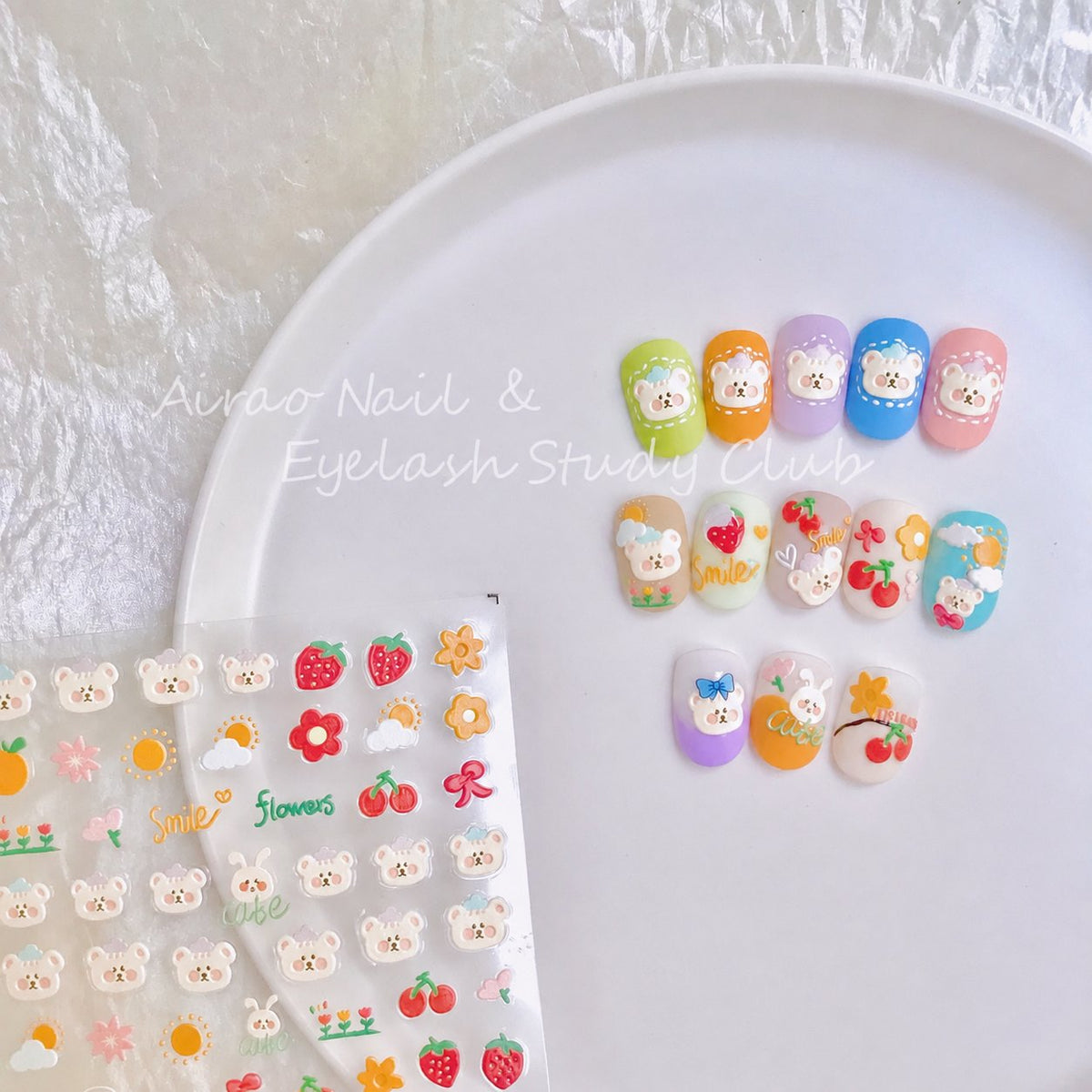 Close-up of colorful bear and flower nail stickers with decorated tips