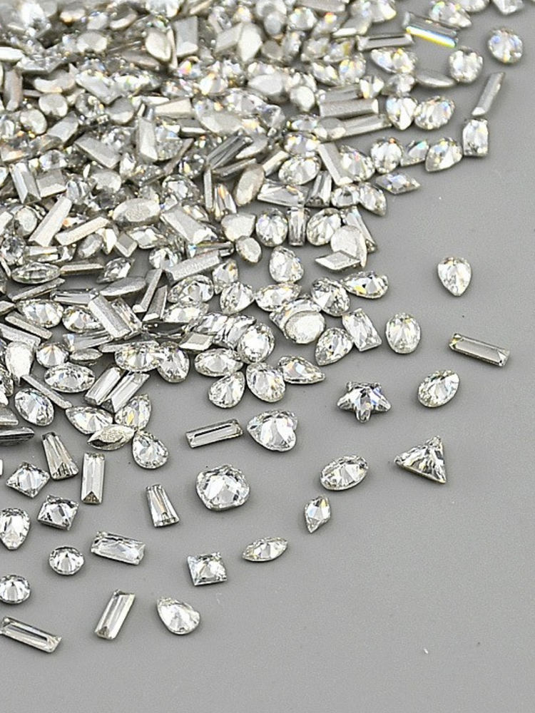 Crystal Shine Series from NFormula Life, showcasing high-clarity crystals and rhinestones in various cuts and shapes, reflecting brilliant light for professional nail art designs.