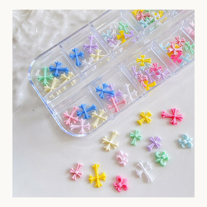 12 grid pastel cross nail charms set with mixed sizes 6mm to 11mm, colorful resin nail decorations for professional nail techs in North America