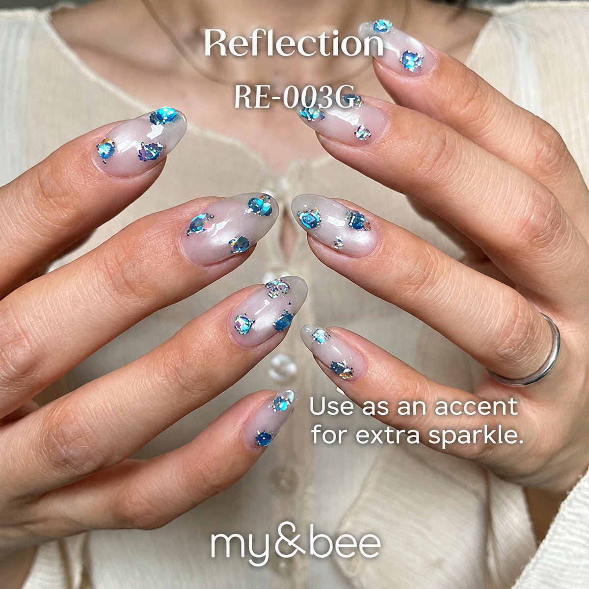 RE-003G milky white glitter manicure with blue reflective accents