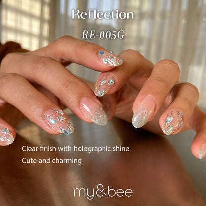 RE-005G clear glitter manicure with pale pink, gold, and blue flakes