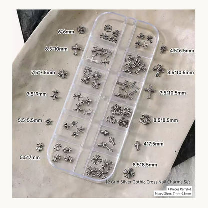 Silver gothic cross nail charms in a 12-grid organizer with loose pieces