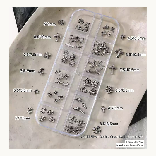 Silver gothic cross nail charms in a 12-grid organizer with loose pieces
