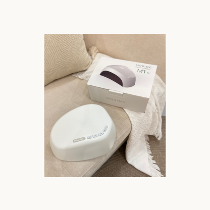 MODING M1s nail lamp displayed with packaging box in a home setting for salon-quality gel curing