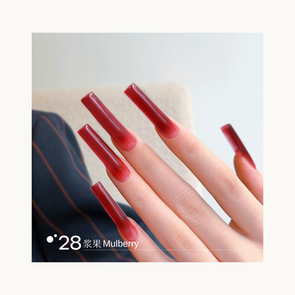 Long coffin-shaped nails painted in shade Q28 Mulberry, a deep berry-red gradient with a rich glossy shine.