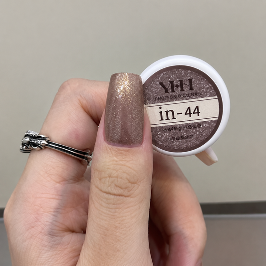 Taupe shimmery nail color gel sample on a painted nail