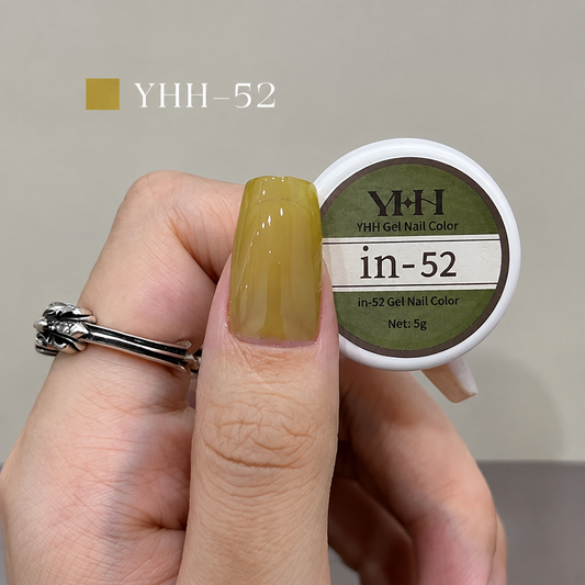 Yellow olive nail color gel sample on a glossy painted nail