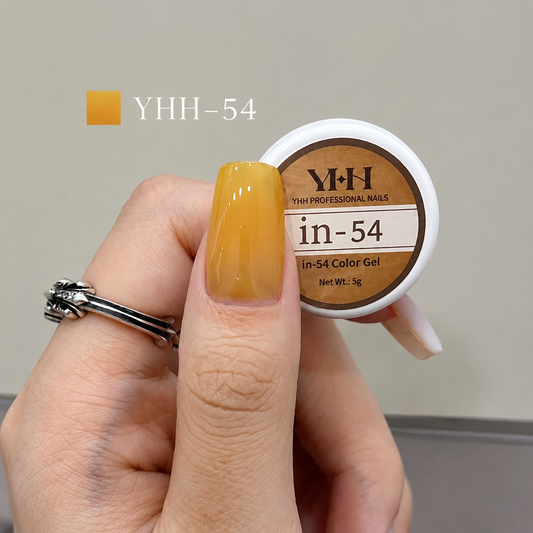 Golden yellow nail color gel sample on a glossy painted nail