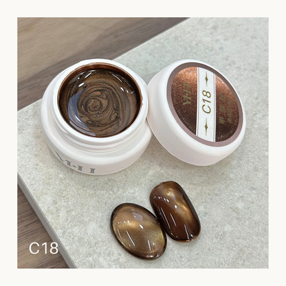 YHH C18 amber syrup cat eye gel swatch showing translucent warm brown magnetic shimmer nail gel