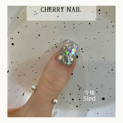 Cherry Nail Christmas Series Sled glitter nail art featuring silver and iridescent chunky glitter flakes creating winter inspired holiday nail decoration
