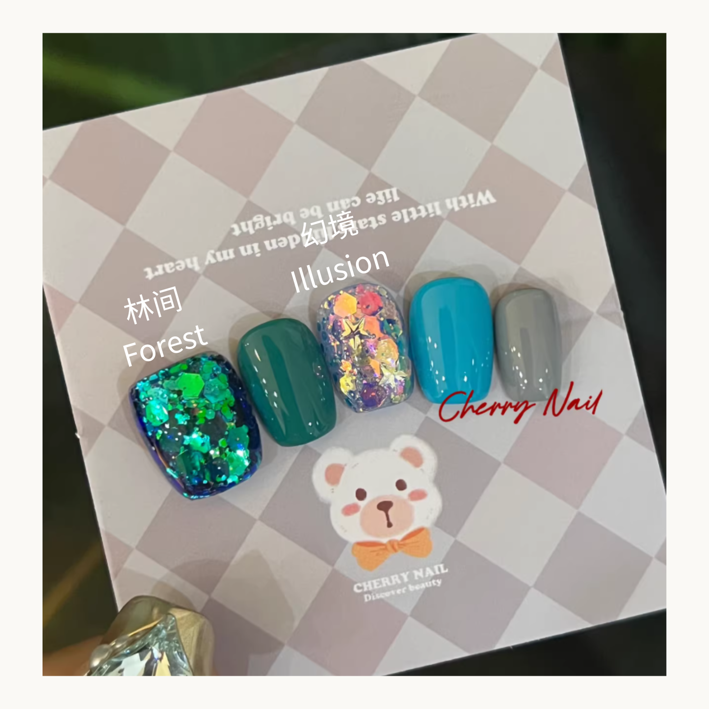 Cherry Nail Glitter Ethereal Reverie Series forest and illusion glitter nail design featuring emerald green glitter nails, teal gel nails, iridescent flake glitter accent, and soft grey gel nail color

