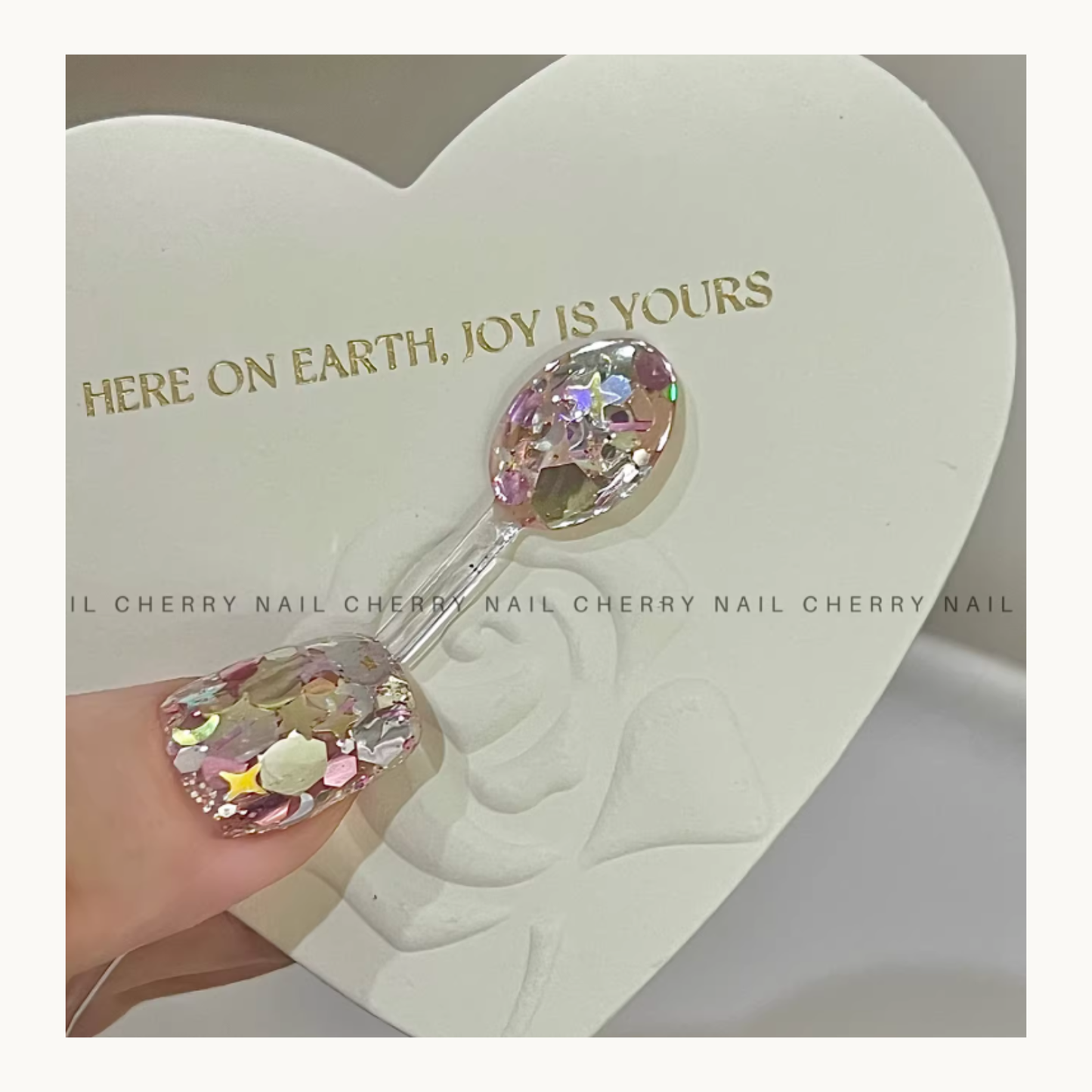 Cherry Nail Little Lollipop mixed glitter nail art with iridescent flakes and star shapes in clear gel design