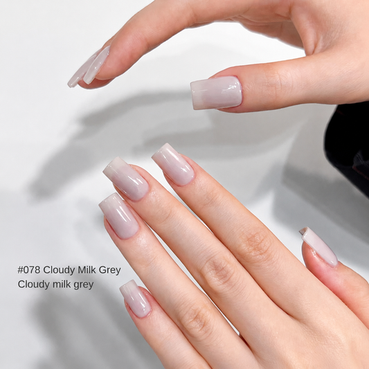 Sheer milky gray nail color gel manicure on two hands
