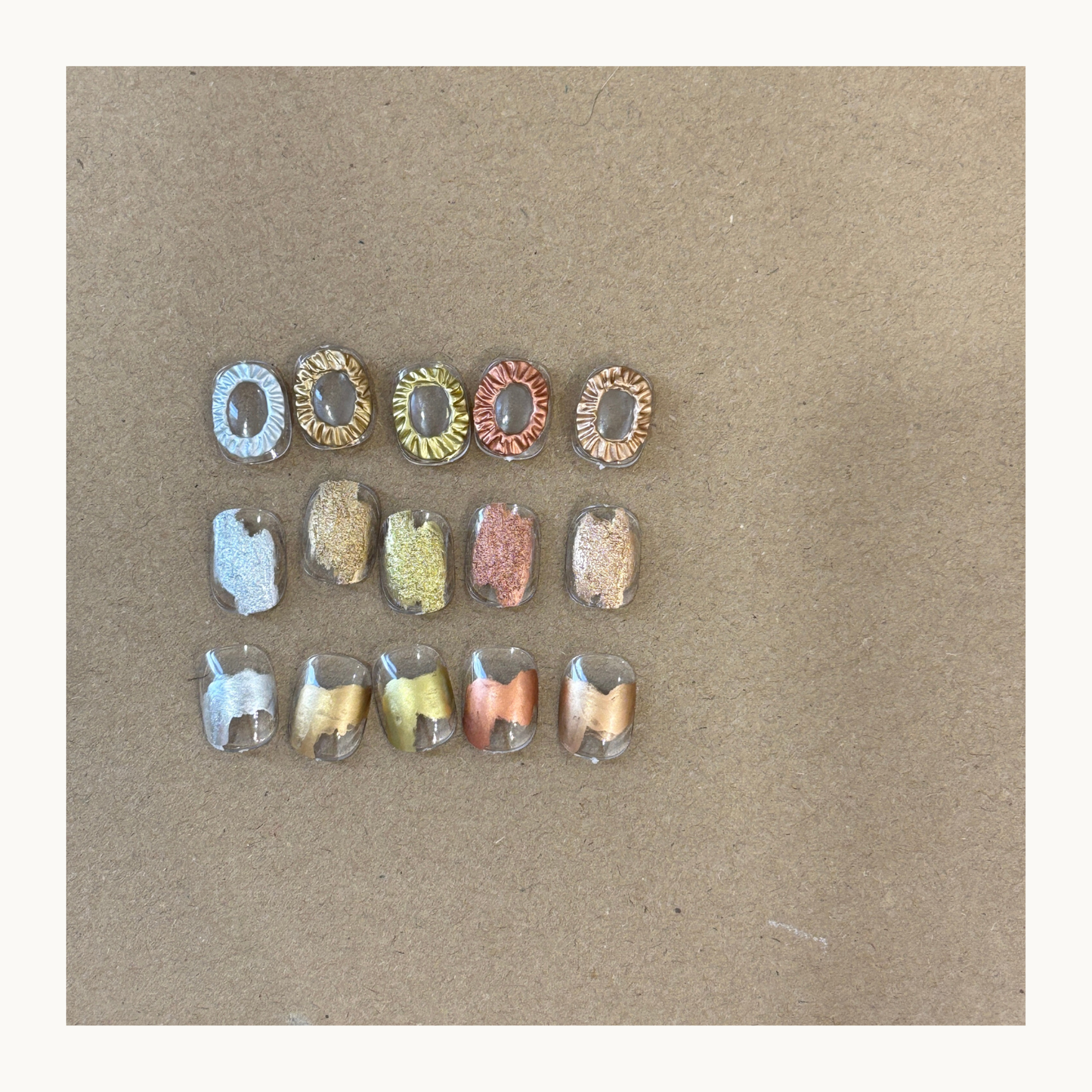 Metallic marbling nail art created with air-dry liquid metal ink showing layered and translucent effects