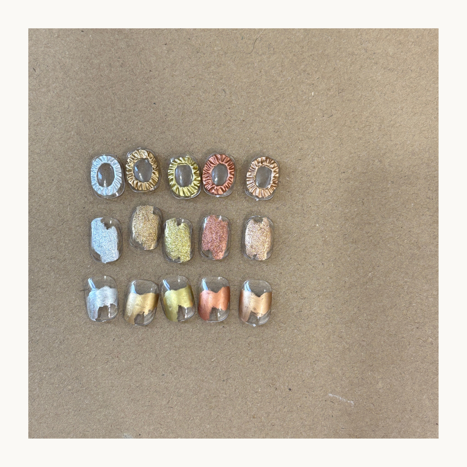 Metallic marbling nail art created with air-dry liquid metal ink showing layered and translucent effects