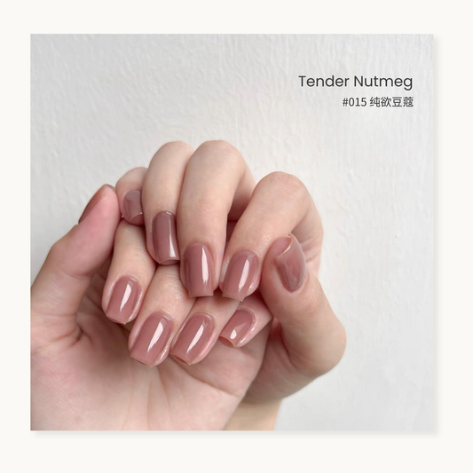 Tender nutmeg gel nail polish manicure on a curled hand
