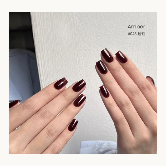 Amber nail color gel manicure on two sets of hands