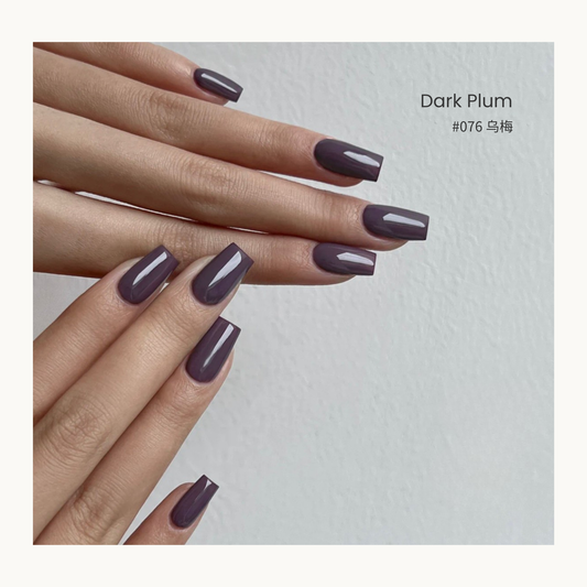 Dark plum gel nail polish manicure on overlapping hands
