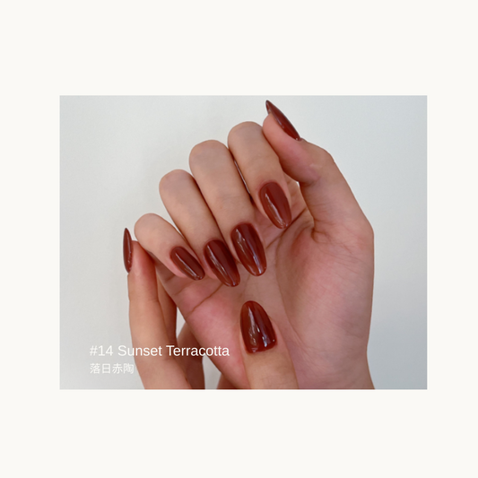 Sheer warm terracotta red gel manicure in the Sunset Terracotta shade