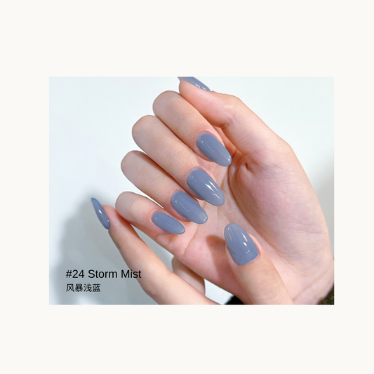 Muted blue-gray gel polish shown on a glossy almond manicure