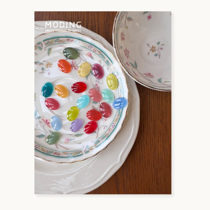 Lifestyle photo of the hema-free, tpo-free and tmpta-free  gel brand Moding French Collection nail gels styled with fruits and Mediterranean tones.