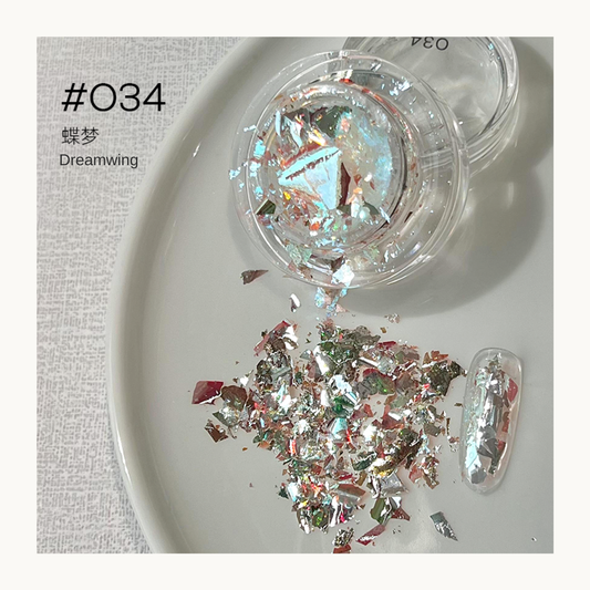 Multicolor iridescent nail art flakes in a jar with a decorated nail swatch