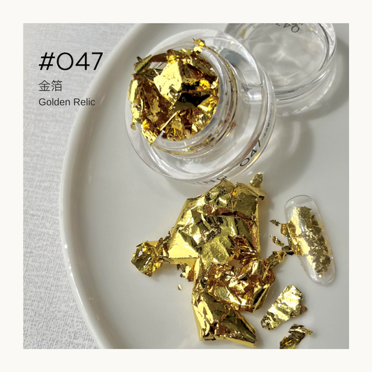 Bright gold reflective nail art flakes in a jar with a decorated swatch