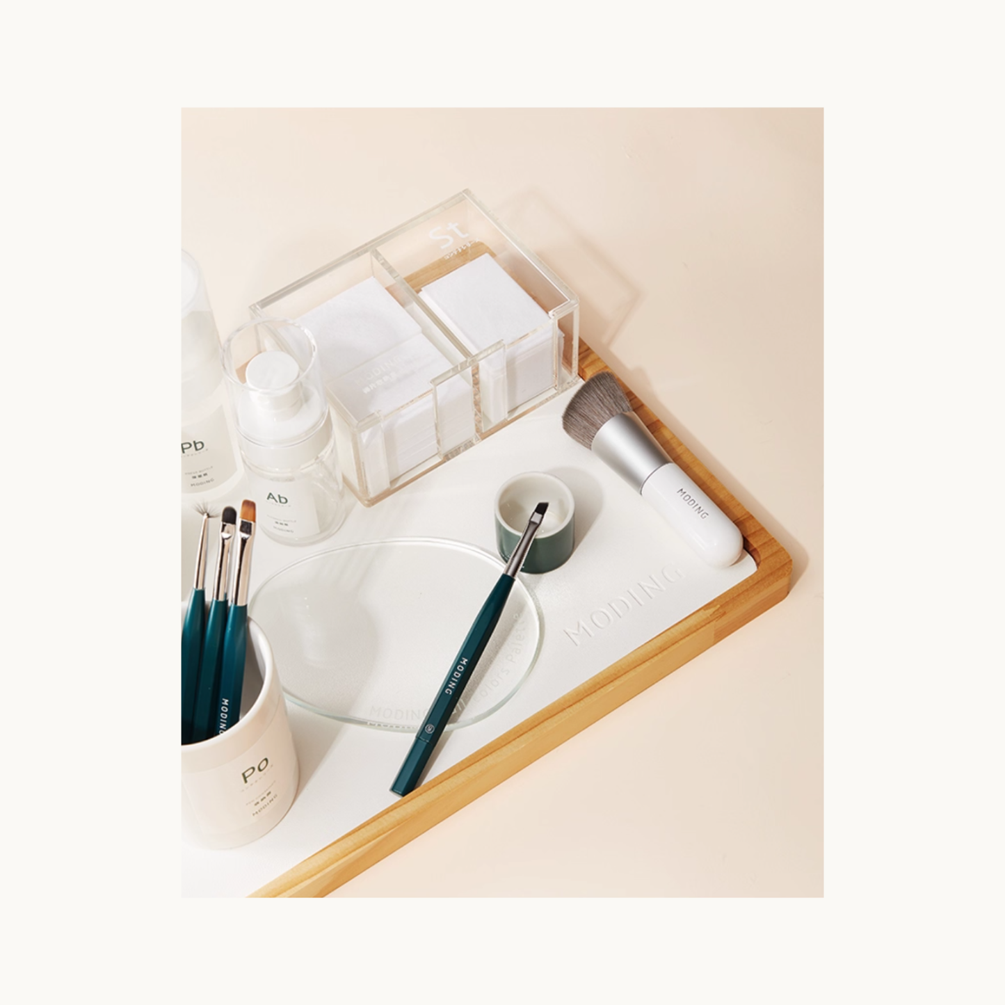 MODING lint-free nail wipes displayed in a clear organizer on a nail workstation with tools