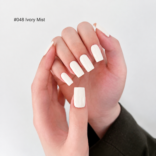 Ivory nail color gel manicure shown on a curled hand