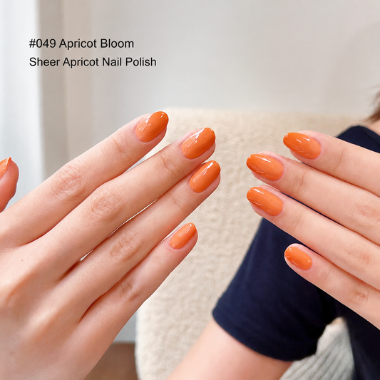 Apricot orange nail color gel manicure displayed on two hands