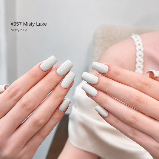 Pale blue-gray nail color gel manicure with a silver bracelet