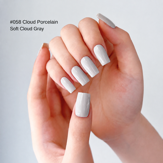 Porcelain white nail color gel manicure on a curled hand