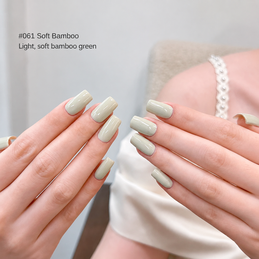Creamy milky-green nail color gel manicure with a silver bracelet