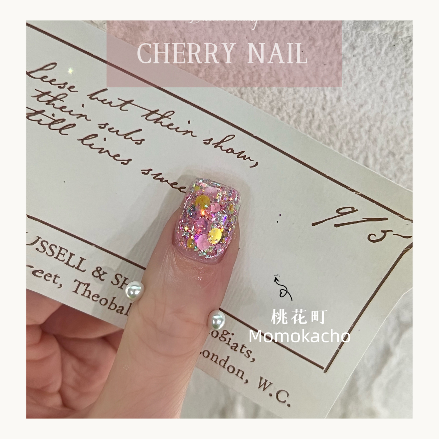 Close-up of Momokacho pink and yellow holographic nail glitter on a finger.