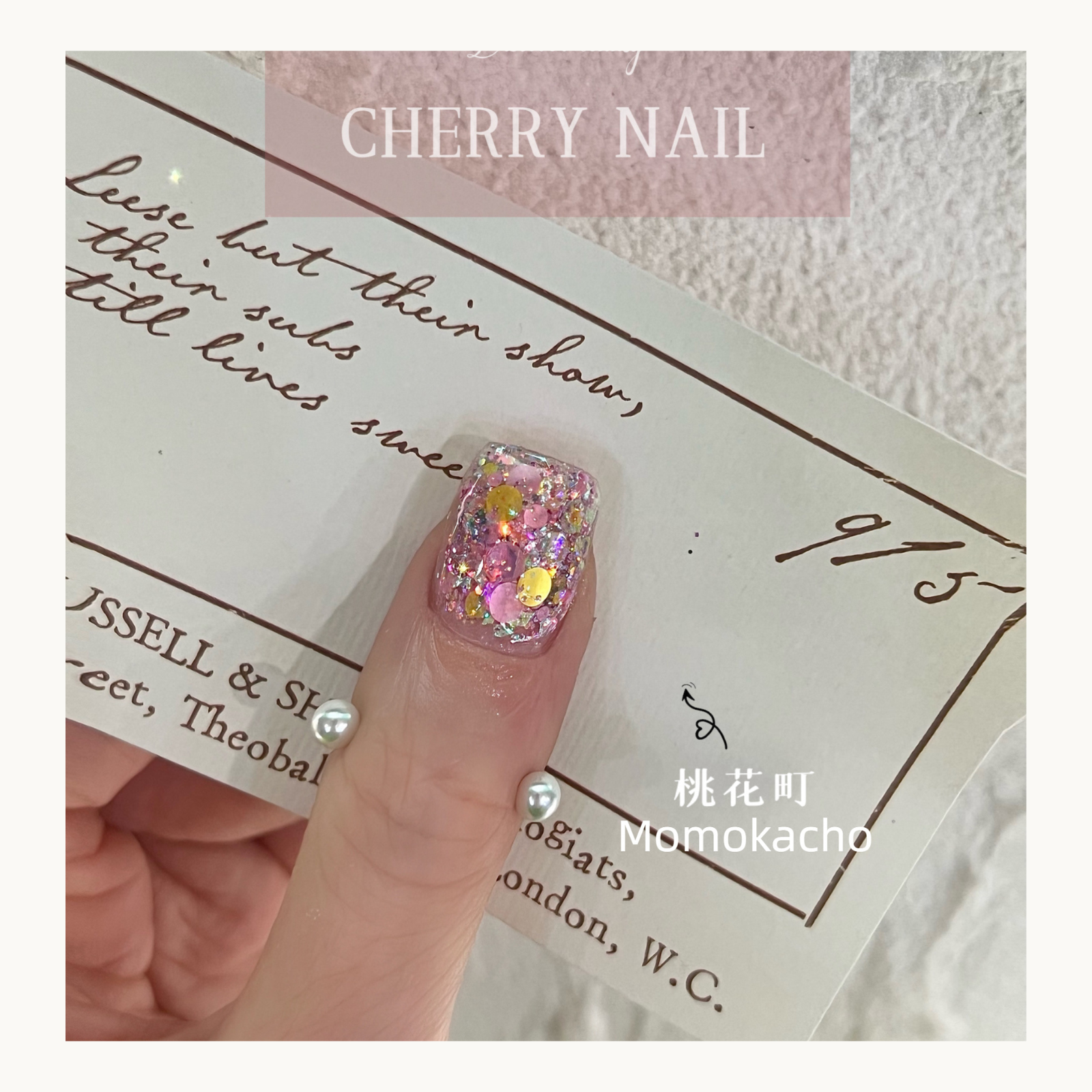 Close-up of Momokacho pink and yellow holographic nail glitter on a finger.