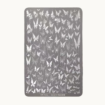 Hand holding MR NAIL W1016 butterfly nail stamping plate with detailed butterfly engraving patterns