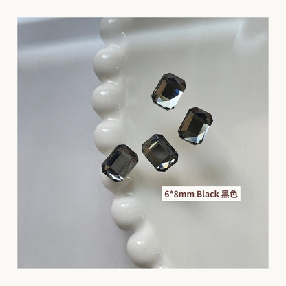 Clear octagon K9 flat back rhinestones black 6x8mm shown on tray and single piece for nail art use