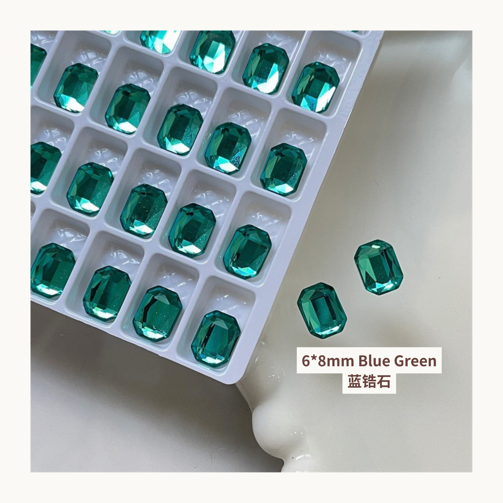 Clear octagon K9 flat back rhinestones blue green 6x8mm shown on tray and single piece for nail art use