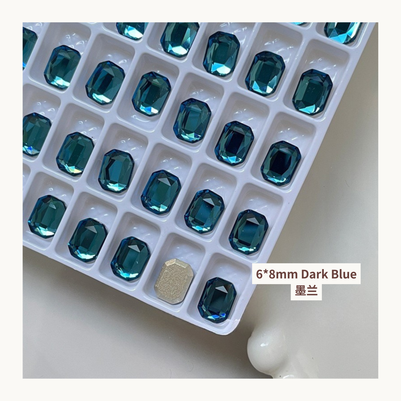 Clear octagon K9 flat back rhinestones dark blue 6x8mm shown on tray and single piece for nail art use