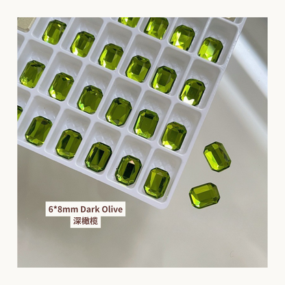 Clear octagon K9 flat back rhinestones dark olive 6x8mm shown on tray and single piece for nail art use