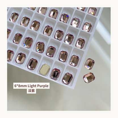 Clear octagon K9 flat back rhinestones light purple 6x8mm shown on tray and single piece for nail art use