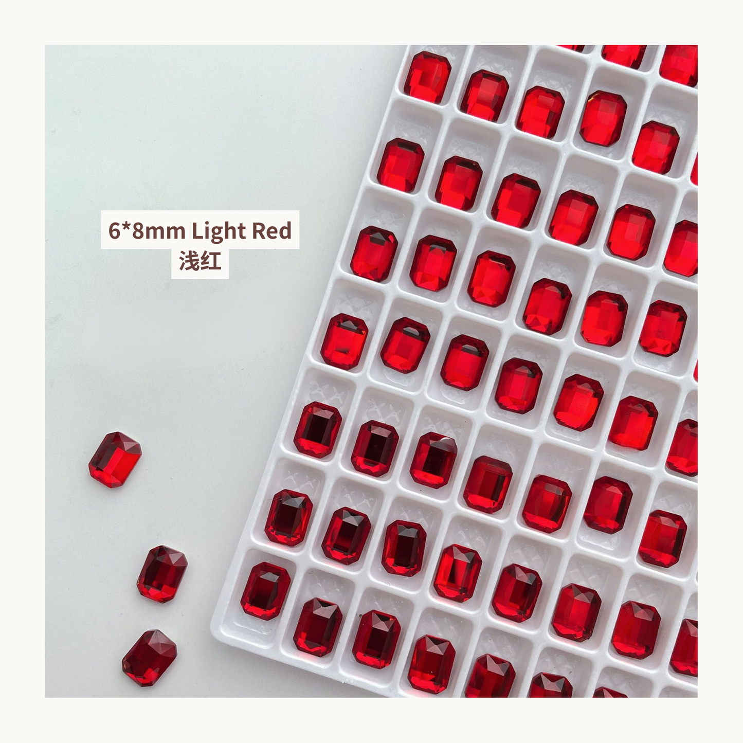Clear octagon K9 flat back rhinestones light red 6x8mm shown on tray and single piece for nail art use